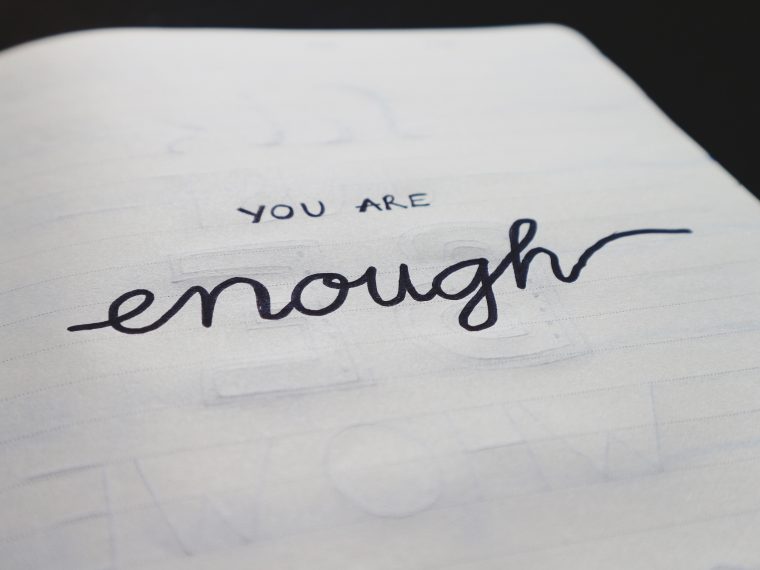 a closeup of a notebook that says you are enough